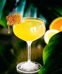 a yellow drink in a glass with a cracker in it at Heritage Haven in Vũ Lâm