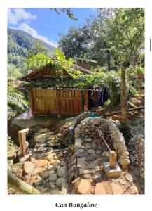 a building on a hill with a stone walkway at A Chỉnh Homestay - Sìn Suối Hồ 