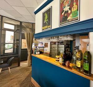 a bar with bottles of wine on the counter at Dyke Hotel in Le Puy-en-Velay