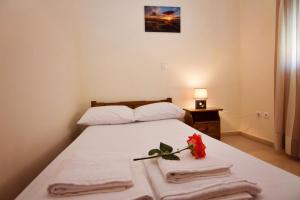 a bedroom with a bed with towels on it at Limnos Family Studios in Angariónes
