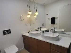 a bathroom with two sinks and a mirror at Sea View, 2 BR, Terrace & Garage in São Domingos | By Airnest in São Domingos de Rana +76 photos