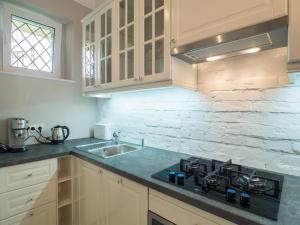 a kitchen with a sink and a stove top oven at Best Apartments Więzienna in Wrocław