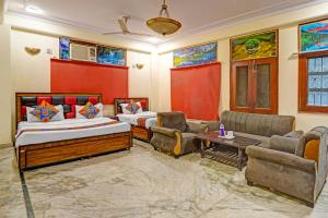 a living room with two beds and a couch at Via Angel Pink Residency in Ghaziabad +21 photos