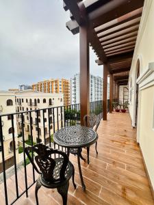 a balcony with a table and chairs and a view at Momento Phu Quoc Hotel in Phu Quoc