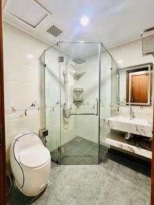 a bathroom with a shower and a toilet and a sink at Momento Phu Quoc Hotel in Phu Quoc +22 photos