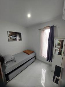 Ένα ή περισσότερα κρεβάτια σε δωμάτιο στο Cantiq Homestay
