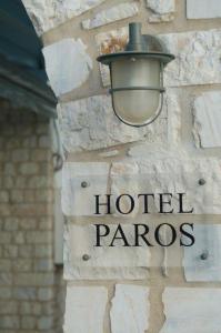 a street light on a hotel panos sign on a building at Hotel Paros in Parikia