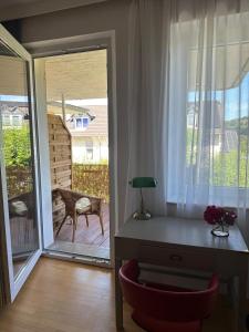 a room with a desk and a sliding glass door at Haus Berlin in Hagen