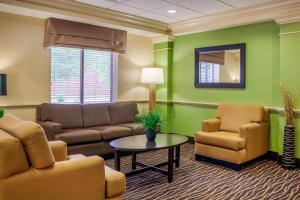 a waiting room with couch chairs and a table at Sleep Inn & Suites Milwaukee Airport in Milwaukee