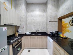 a kitchen with a sink and a stove at Supernova Haven 1BR - Near Yas Mall & Marina in Abu Dhabi