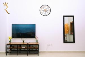 a living room with a tv and a mirror at Supernova Haven 1BR - Near Yas Mall & Marina in Abu Dhabi +43 photos