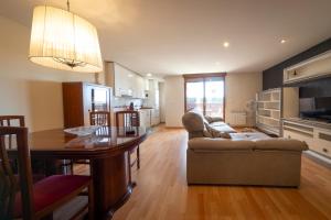 a kitchen and living room with a couch and a table at Casa Venerable Carabantes in Soria