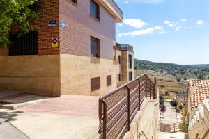 a building with a fence next to a street at Casa Venerable Carabantes in Soria