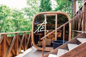 洲本市Villa SCALA的甲板上有一个圆形镜子的木制楼梯