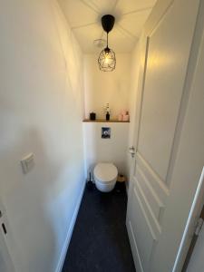 a small bathroom with a toilet and a door at Appartement Sedan in Sedan