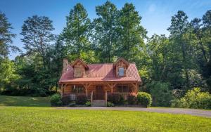 a wooden house with a red roof at Holden On in Pigeon Forge