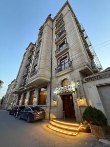 a building with a car parked in front of it at Capitol Hotel Stay in Baku