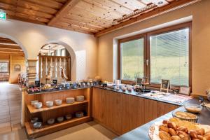 a large kitchen with a counter with bread on it at Pension Schneerose - Wildschönau - PREMIUM CARD im Sommer in Wildschönau