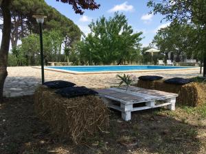 a picnic table in front of a swimming pool at Tenuta "Li Santi" in San Cesario di Lecce