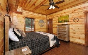 a bedroom with a bed and a ceiling fan at Dip in the Smokies in Gatlinburg +45 photos
