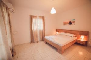 a bedroom with a bed and a window in it at Nerina Studios Agios Nikitas in Agios Nikitas