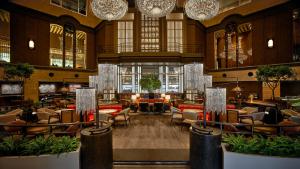 a hotel lobby with chairs and tables and chandeliers at Hyatt Regency Tokyo in Tokyo