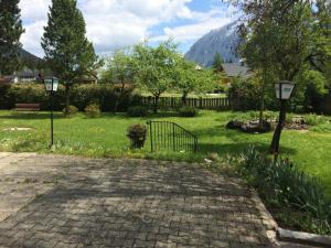 a brick walkway with a gate in a park at Hotel Aquamarin in Bad Mitterndorf