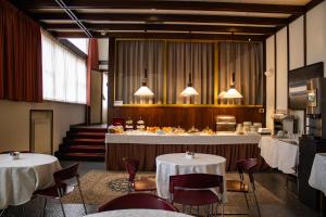 a restaurant with two tables and chairs and a counter at Hotel Napoleon Rimini - City & Station in Rimini