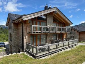 a log house with a large deck on the side at Apartman Brhliska in Belá