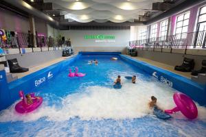 a group of people in a swimming pool at citywave Vilnius self check-in in Vilnius