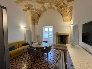a living room with a table and a couch at La Torretta dimora storica in Montesano Salentino