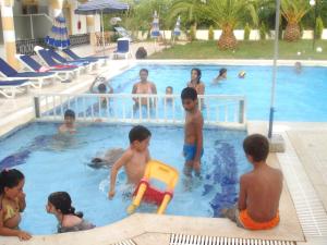 a group of children playing in a swimming pool at Alessandro in Sidari