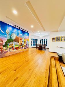 a large room with a wooden floor and a painting on the wall at LESTARI INN RESIDENCE in Kuantan