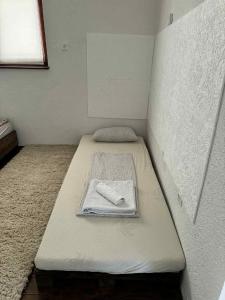 un lit avec une serviette dessus dans une chambre dans l'établissement Cottage Arinda, à Jajce 20 autres photos