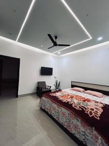 a bedroom with a bed and a ceiling fan at Euphoria escape in Tezpur