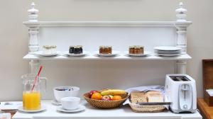 a kitchen counter with food and bread and a toaster at Cruce´s Hotel Boutique in Buenos Aires