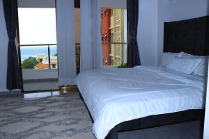 a bedroom with a large bed and a large window at Luxurious apartments Mombasa in Mombasa +20 photos