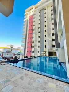 a swimming pool in the middle of two buildings at Luxurious apartments Mombasa in Mombasa