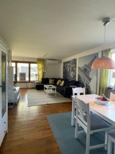 a living room with a couch and a table at Centralt belägen villa i Öjebyn, Piteå in Piteå