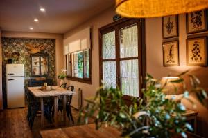 a kitchen with a table and a refrigerator at Sabina Hotel in Arenas de San Pedro