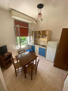 a kitchen with a table and chairs and a dining room at L'Ostello in Vasto
