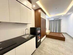 a kitchen with white cabinets and a sink at 25House Cozy Apartment near West Lake & Airport in Hanoi +10 photos
