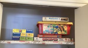 a pile of books on a shelf in a room at Gîte Les Perelles in Pontcharra