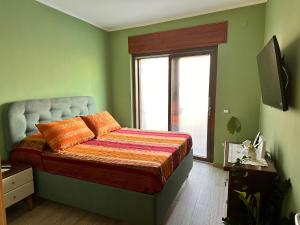 a bedroom with a bed with a large window at Garçonnière Casa Caterina in Ischia +25 photos