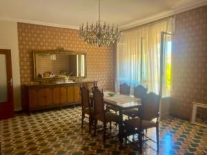 a dining room with a table and chairs and a mirror at Casa Nicola - Welchome in San Vito Chietino +4 photos