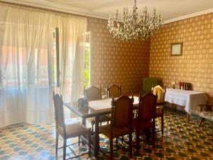 a dining room with a table and chairs and a chandelier at Casa Nicola - Welchome in San Vito Chietino