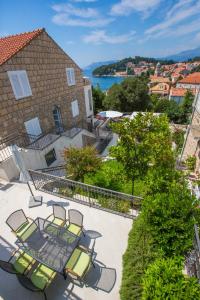 a patio with chairs and a view of the water at Villa Pepo in Cavtat