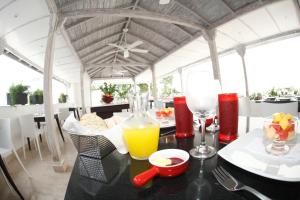 a black table with a glass of orange juice on it at Zalmedina Hotel in Cartagena de Indias