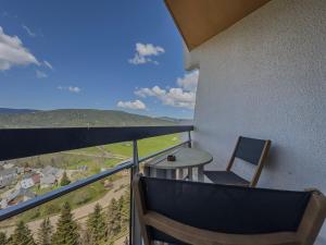 a balcony with a table and a chair at Le Chamois - Au pied des Pistes in Villard-de-Lans
