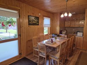 a dining room with a wooden table and chairs at Relax Island Guesthouse in Izvoare